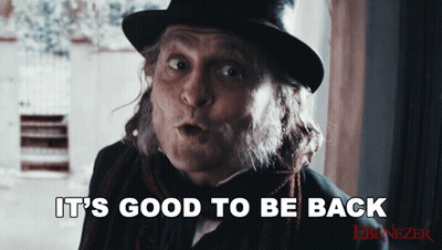 Man In Top Hat And Scarf Says It's Good To Be Back GIF