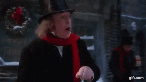 Man In Top Hat And Scarf Walking Down Street In Christmas Story GIF