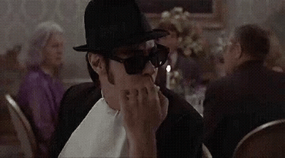 Man In Top Hat And Sunglasses Sitting At Table With Candle GIF