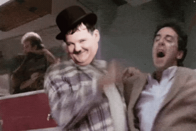 Man In Top Hat Dancing With Suited Man GIF