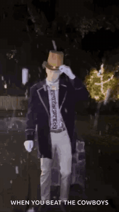 Man In Top Hat Standing In Dark With Light Behind Him Says When You Beat The Cowboys GIF