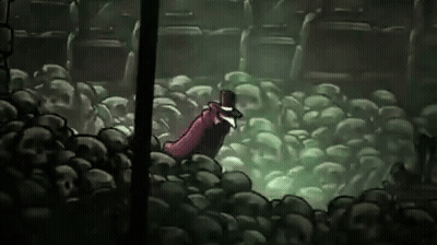 Man In Top Hat Standing In Pile Of Skulls In Cave GIF