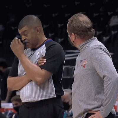 Man In Toronto Raptors Shirt Talking To Another Man GIF