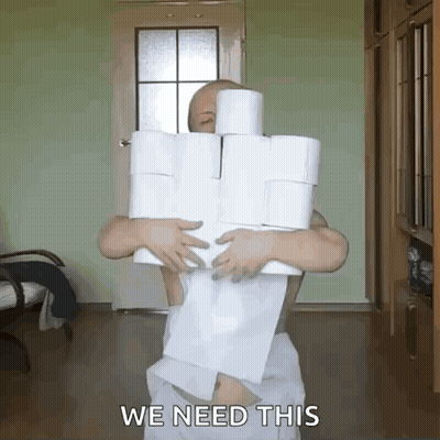 Man In Towel Holding Toilet Paper Rolls Saying We Need This GIF