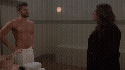 Man In Towel Standing Next To Woman GIF
