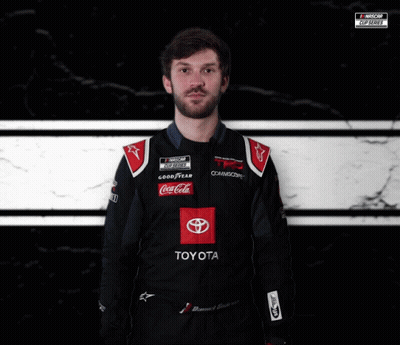 Man In Toyota Racing Suit In Front Of NASCAR Logo GIF