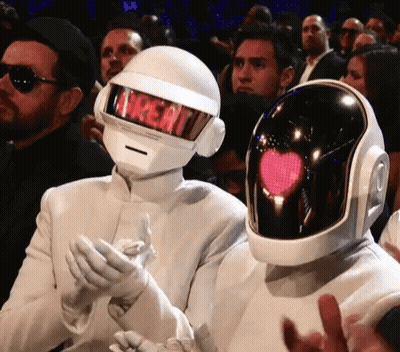 Man In Treat Helmet Next To Man In Heart Helmet GIF