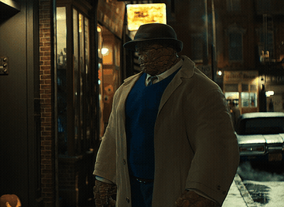 Man In Trench Coat And Hat In Front Of No Parking Sign GIF