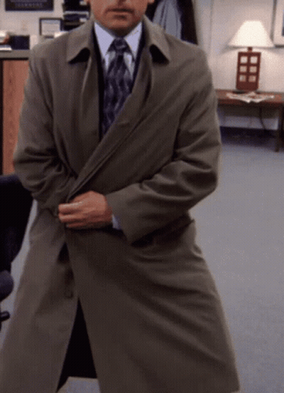 Man In Trench Coat And Tie By Lamp GIF