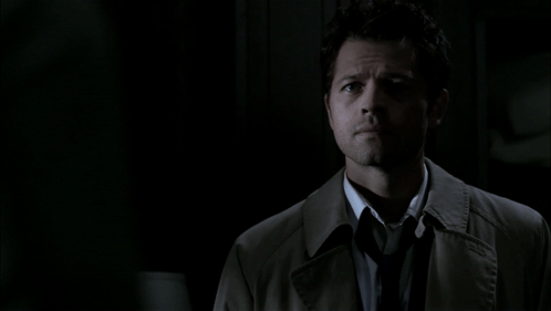 Man In Trench Coat And Tie Looks At Camera GIF