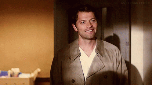 Man In Trench Coat And White Shirt Smiling GIF