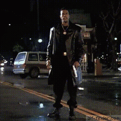 Man In Trench Coat Dancing On Street At Night GIF