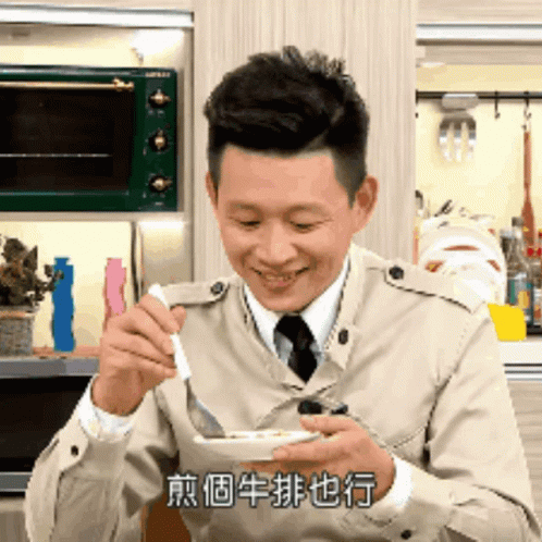 Man In Trench Coat Eating With Spoon GIF