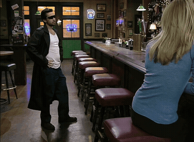 Man In Trench Coat In Front Of Guinness Bar GIF