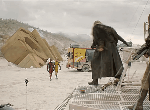 Man In Trench Coat In Front Of Snickers Truck GIF