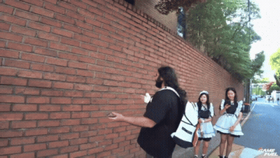Man In Trench Coat Kneeling On Stairs GIF