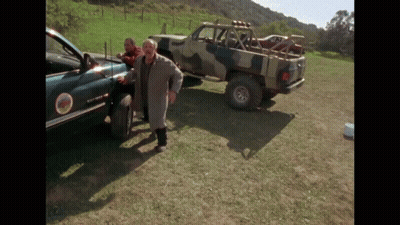 Man In Trench Coat Next To Sierra Truck GIF