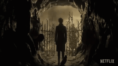 Man In Trench Coat Standing In Cave With Netflix Logo GIF