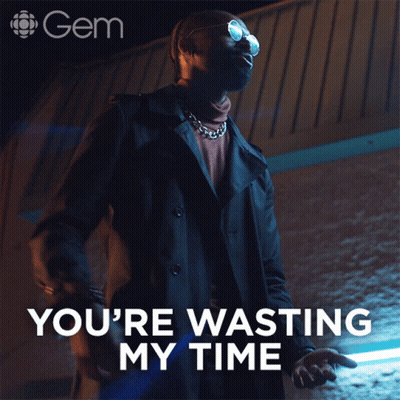 Man In Trench Coat Standing In Front Of Sign Saying You're Wasting My Time GIF