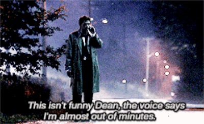 Man In Trench Coat Talking On Cell Phone Saying This Isn't Funny GIF
