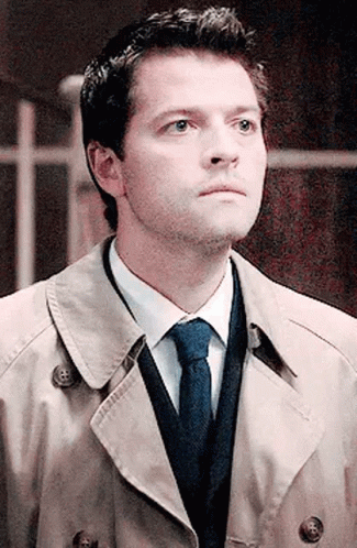 Man In Trench Coat Tie And Sweater Looking Up GIF