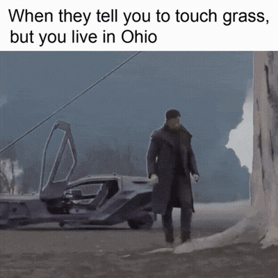Man in Trench Coat Walking in Front of Car When They Tell You to Touch Grass