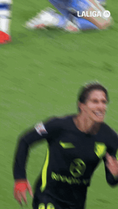 Man In Trench Coat Walking On Soccer Field Surrounded By Security Guards GIF