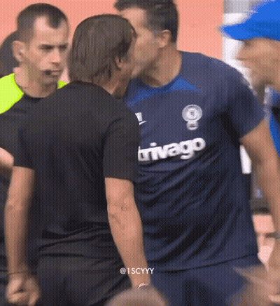 Man In Trivago Jersey Kissing Another Man GIF