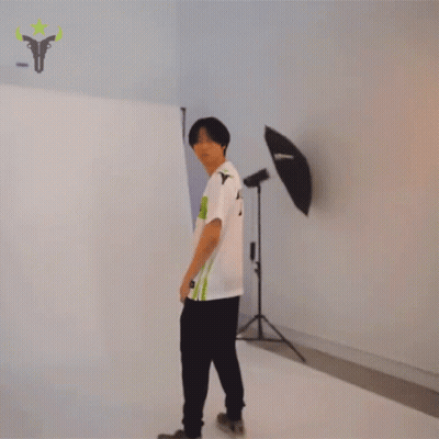Man in TU Shirt Stands in Front of Wall