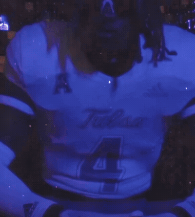 Man In Tulsa Jersey Standing In Front Of Purple Background GIF