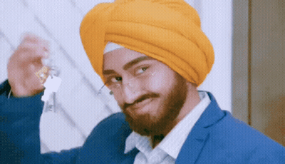 Man In Turban And Glasses Holding Bottle GIF