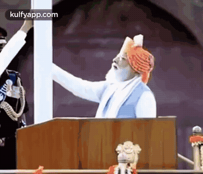 Man In Turban Giving Speech At Podium GIF