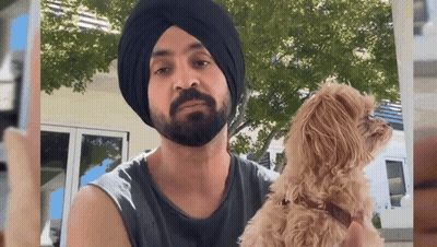 Man In Turban Holding Small Dog GIF