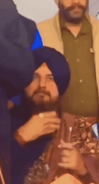 Man In Turban Sitting In Crowd GIF
