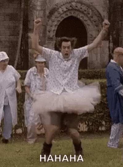 Man In Tutu Dancing In Field With Group GIF