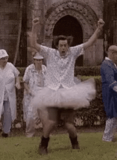 Man In Tutu Dancing In Field With Group GIF