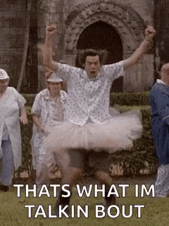 Man In Tutu Jumping In Air While Group Watches GIF