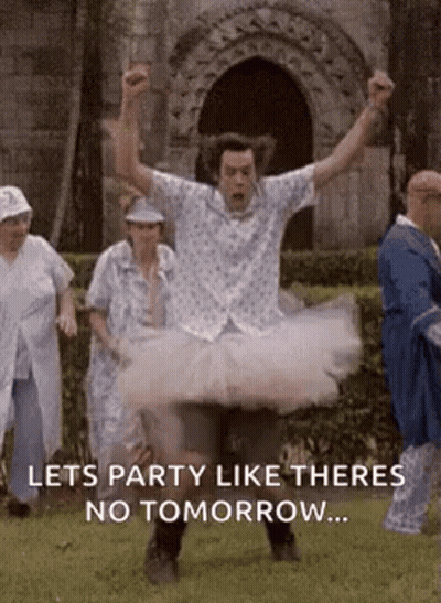 Man In Tutu Jumping In Air With Group Behind GIF