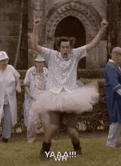Man In Tutu Jumping While People Watch GIF