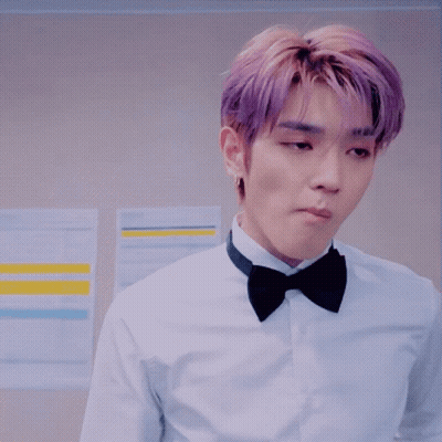 Man In Tuxedo Adjusting Bow Tie In Front Of Disney Plus Sign GIF