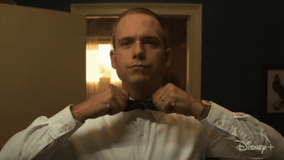 Man In Tuxedo Adjusting Bow Tie In Front Of Disney Plus Sign GIF