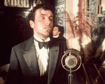 Man in Tuxedo and Bow Tie at Microphone