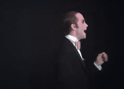 Man In Tuxedo And Bow Tie At Podium GIF