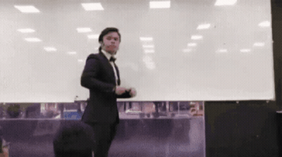Man In Tuxedo And Bow Tie At Whiteboard GIF