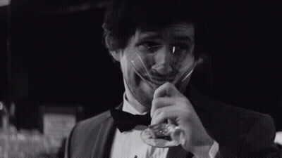Man In Tuxedo And Bow Tie Holding Glass GIF