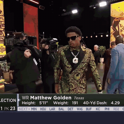 Man In Tuxedo And Bow Tie In Front Of Wr Matthew Golden Sign GIF