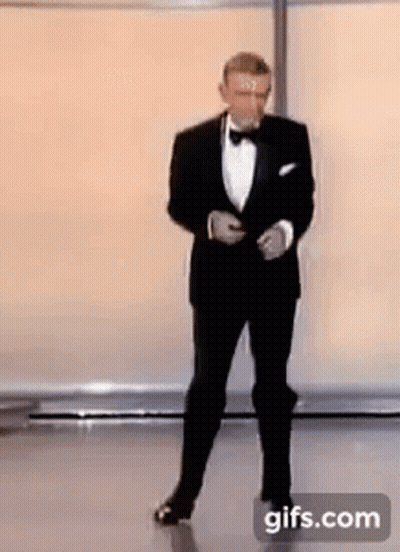 Man In Tuxedo And Bow Tie On Stage GIF