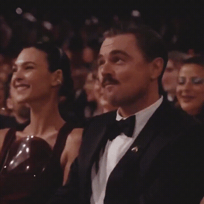 Man In Tuxedo And Bow Tie Sitting Next To Woman GIF