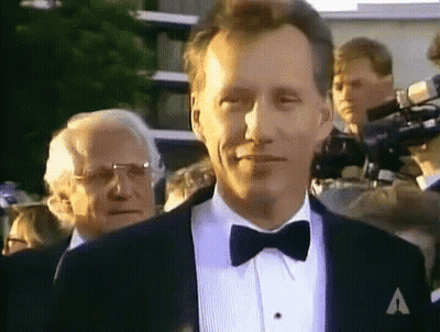 Man In Tuxedo And Bow Tie With A On Jacket GIF