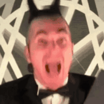 Man In Tuxedo And Bow Tie With Devil Horns GIF